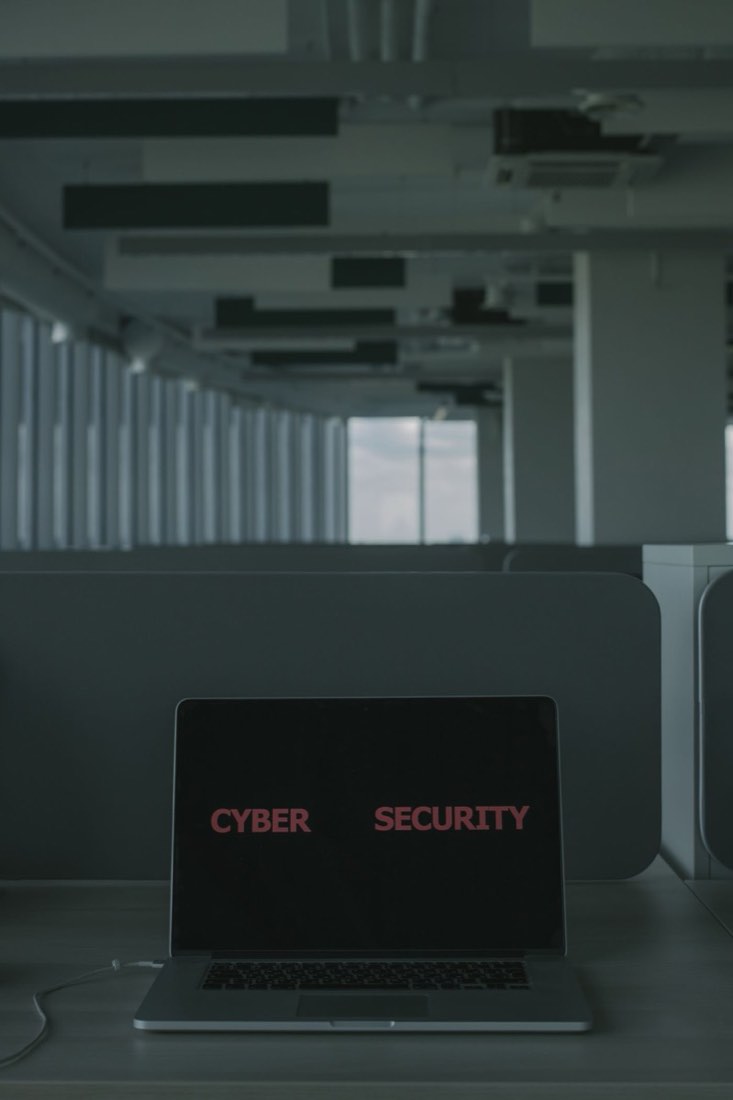 Laptop showing a cybersecurity screen in an office